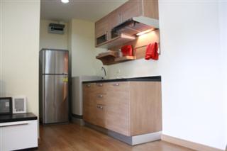 Kitchen area with washing machine and fridge/freezer